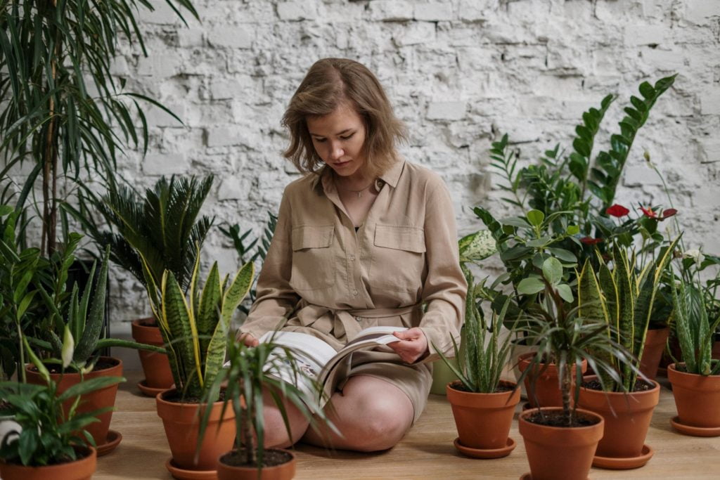 a woman sitting in a potted plant
