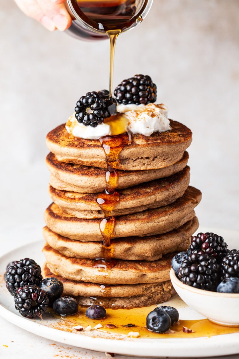 a stack of pancakes with fruit on top