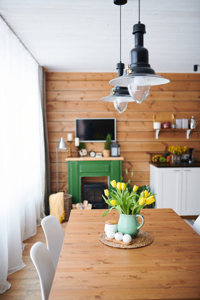 shot of wooden home dinning table with kitchen