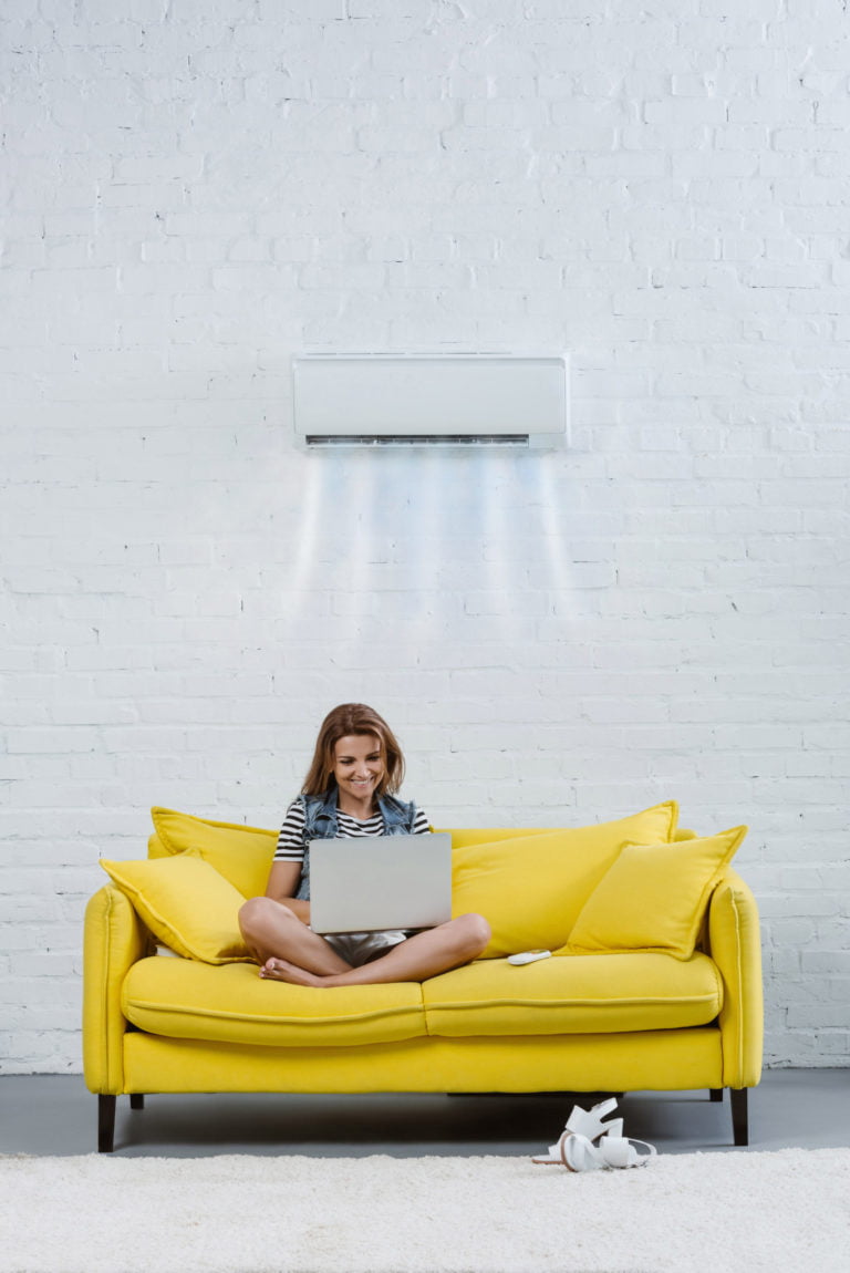 woman on a yellow couch at home