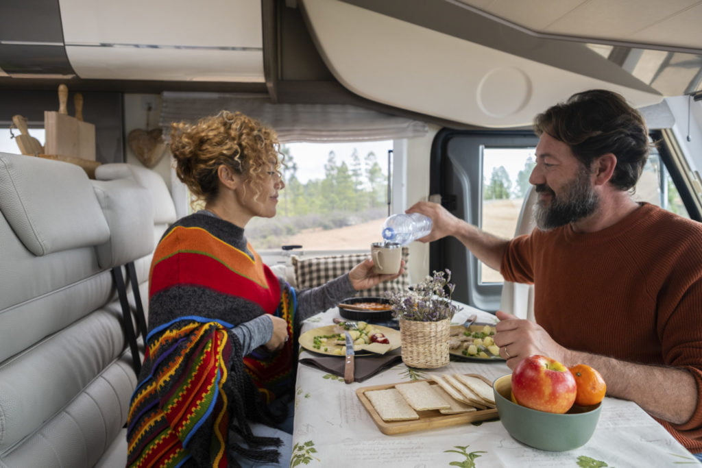 couple having lunch in a camper