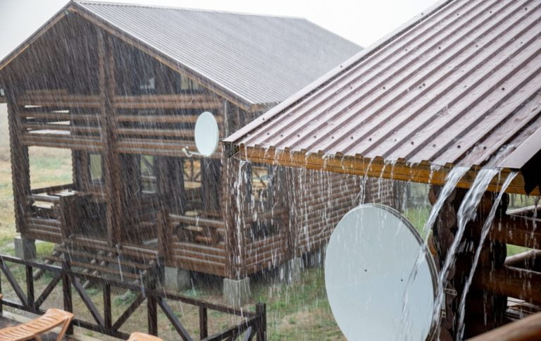 A large recreation center with wooden houses was flooded with heavy pouring rain, and the downpour ruined the good warm summer sunny weather and joyful holidays