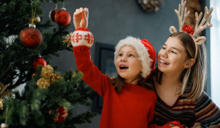 Kids are having fun near Christmas tree