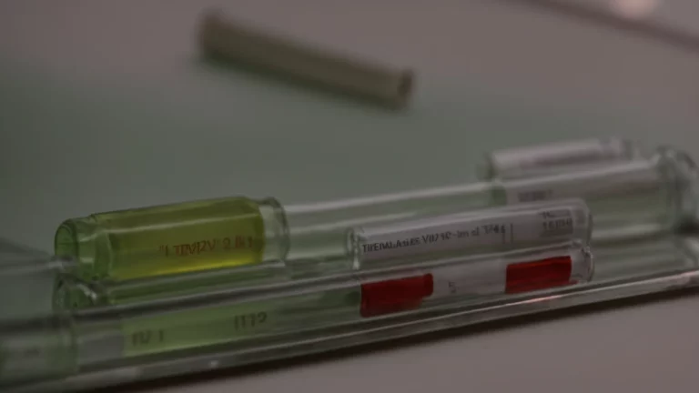 two vials of medication side by side on a table, each labeled for type 2 diabetes treatment, under bright clinical light.